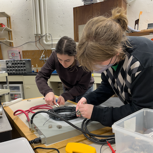 Emma and Emma in the lab setting up an electromagnet
