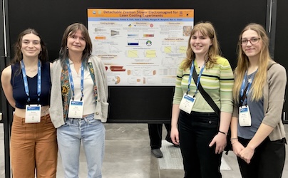 A portrait of the lab members in front of their conference poster