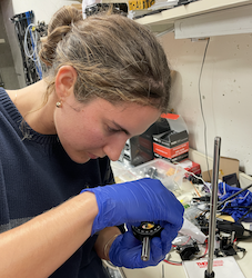 Stella mounts an optic in the lab