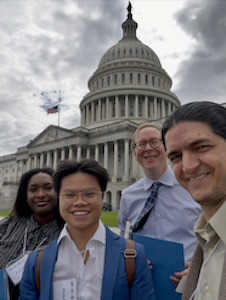 Four physicists in front of the US capitol building